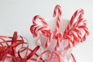 Christmas candy Cane and red ribbon on white background