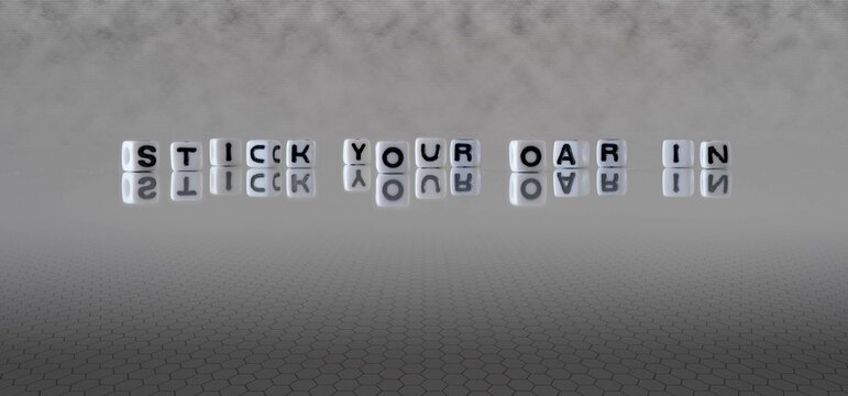 stick your oar in word or concept represented by black and white letter cubes on a grey horizon background stretching to infinity