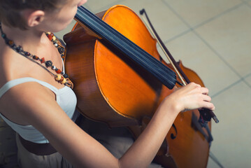 Young woman playing cello on the concert at night © Solid photos