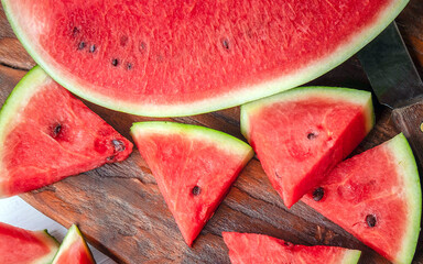 Close up of tasty sliced fresh watermelon on a wooden chopping board