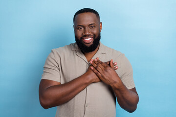 Photo of positive cheerful person hands palms touch heart toothy smile isolated on blue color background