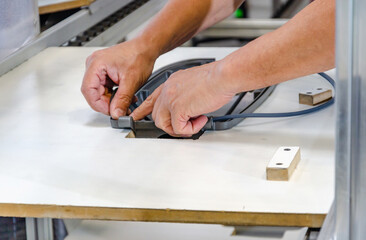Production of hulls of street lamps. The hands of a lamp worker.