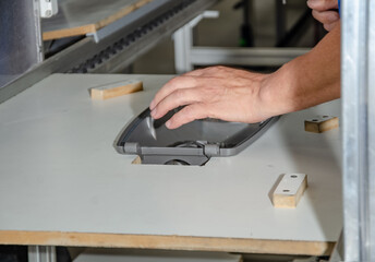 View of the employee's hands in production. Production of street lanterns.