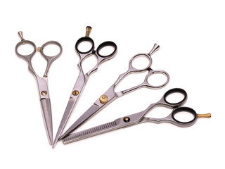 A set of four professional hairdressing scissors. Scissors for cutting and thinning. Isolated on white background