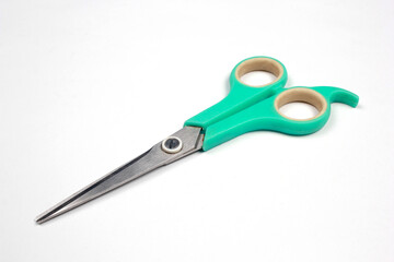 Green tosca scissors isolated on white background.