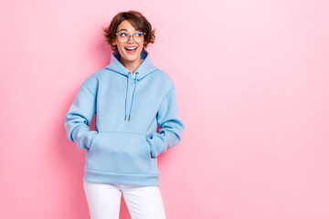 Portrait photo of young adorable nice girlish woman wear blue hoodie dreamy look empty space...