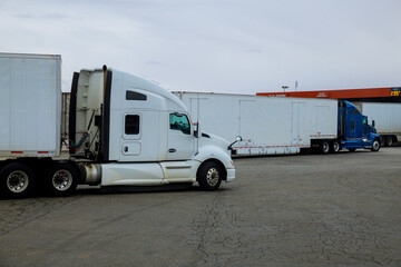 Resting place the truck stop various types of trucks in parking lot the highway with gas station for refueling car in the US.