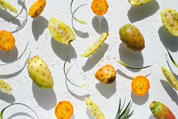 Exotic fruits, yellow and orange prickly pears, healthy cactus fruits on off white background with...
