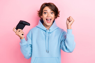 Photo of young attractive pretty cute woman wear blue hoodie fists up hold gamepad addicted player...