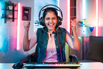 exicited gamer celebrating online live video gaming competition victory or winner by looking camera at home - concept of achievement, successful and championship. © WESTOCK