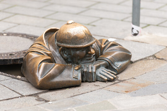 Bratislava. Slovakia. May 2019. Monument to a plumber in Bratislava. A figure peeking out of a city well.