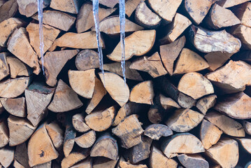 Stacked stack of firewood. Large woodpile with chopped wood. Stacked stack of firewood from the end.