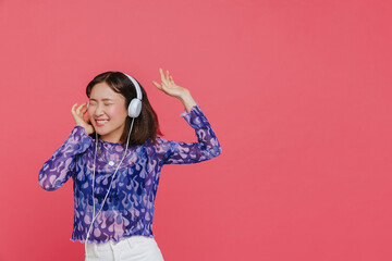 Portrait of young beautiful smiling happy asian girl in headphones