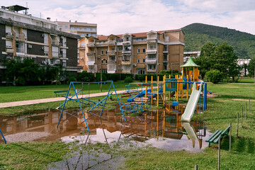 Flooded playground after rain in the yard of an apartment building. High quality photo