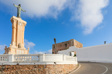 Estatua de Cristo a la entrada del santuario de la Virgen del Toro, en la cima de Monte Toro, la montaña más alta de la isla de Menorca. - obrazy, fototapety, plakaty