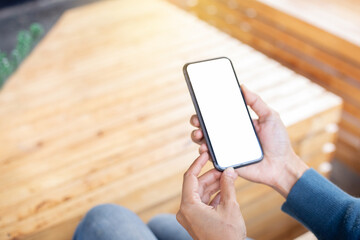 cell phone blank white screen mockup.hand holding texting using mobile on desk at office.background empty space for advertise.work people contact marketing business,technology