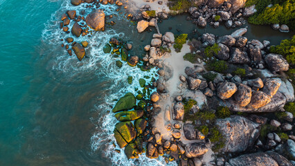 Ocean tropical landscape, rocky coast with fishing boats, drone shot, water and beach.