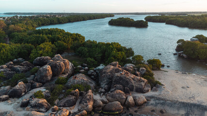 Ocean tropical landscape, rocky coast with fishing boats, drone shot, water and beach.