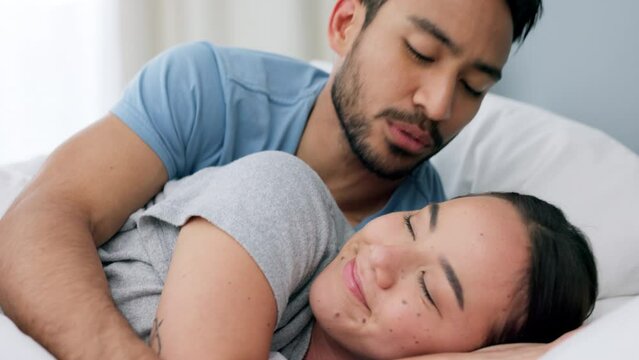 Relax, couple and love in bedroom sleep, cuddle and comfort in happy relationship together at home. Man and woman lying in bed relaxing, cuddling and smile in comfortable house and morning happiness