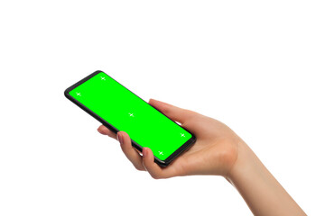 Smartphone with green screen in a woman's hand, isolated, copy space. Phone is angled.