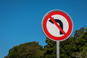 No left turn sign against blue sky. Traffic signs. Prohibited from turning left.