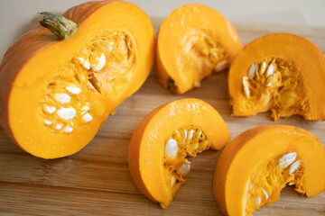 pieces of pumpkin on a wooden surface. Diet, proper nutrition, pumpkin benefits, vitamins all year round, rich harvest