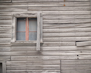 Old unpainted wall with window