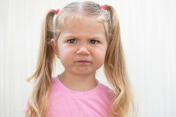 Portrait of a caucasian child with sceptic face expression. 