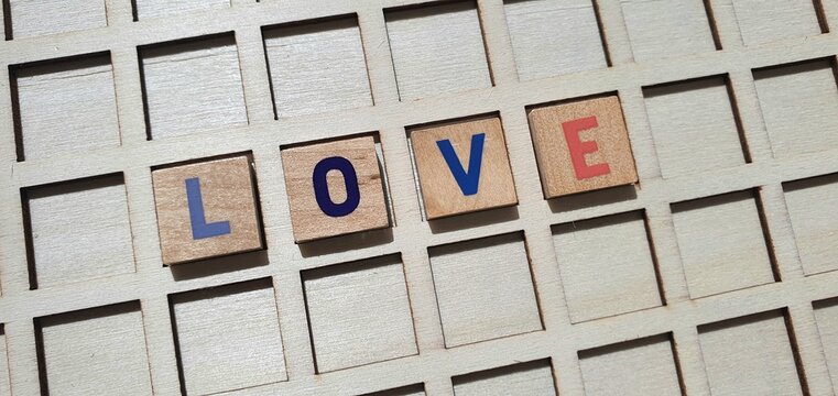 The words "Iove " on a blackboard. The word "love" from wooden letters. Declaration of love. Letter from wooden letters.