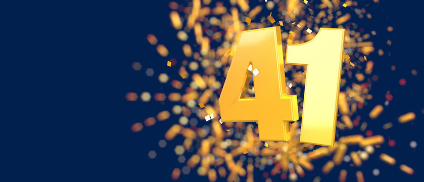 Gold number 41 in the foreground with gold confetti falling and fireworks behind out of focus