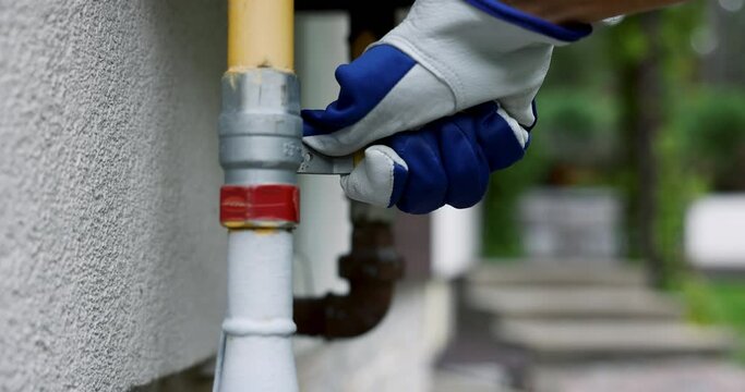 hand closes the household gas pipe valve