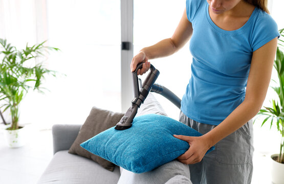 Woman cleaning the couch