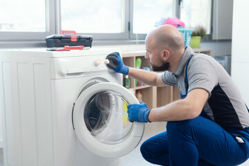 Obraz premium Professional technician checking a washing machine