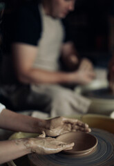 Hands of potter sculpt handmade earthenware on pottery wheel.