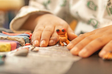 plasticine figure molded by child's hands