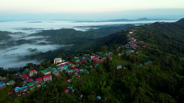 Bird's eye view of rural houses on green hills of Sajek Valley in Bangladesh