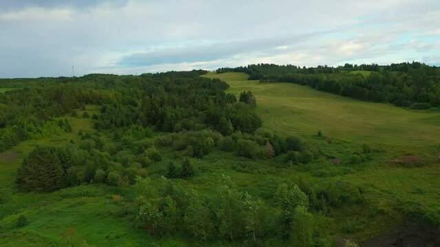 Aerial drone video passing over a country property in the mountains of Petite Matane