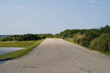 Straight road in front of the entrance of Cape Higashi-Hennazaki Park.