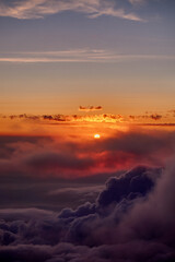 Flying above the clouds during sunset, Norway.