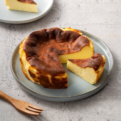 Delicious sliced baked Basque Burnt Cheesecake in a plat served for eating.
