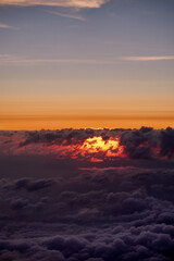 Fototapeta na wymiar Flying above the clouds during sunset, Norway.