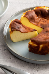 Delicious sliced baked Basque Burnt Cheesecake in a plat served for eating.