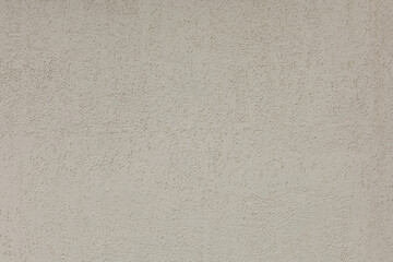 Texture of beige plaster wall. Rough surface bark beetle