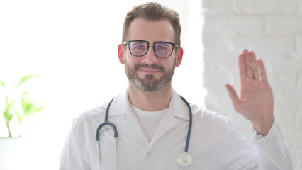 Portrait of Doctor Waving Hand for Hello, Welcoming