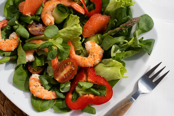 A healthy green garden salad with cooked shrimp