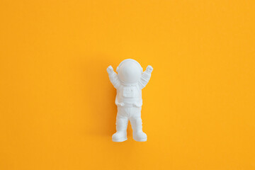 plaster figure of an astronaut on a yellow background