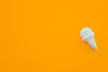 plaster figure of ice cream on a yellow background