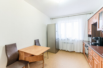 Russia, Moscow- May 21, 2020: interior apartment kitchen and dining room, refectory area cooking equipment, table furniture stove