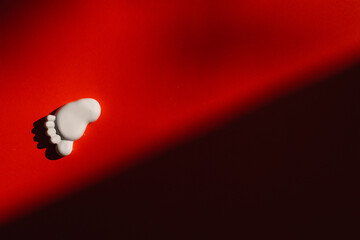 plaster figure of a foot on a red background