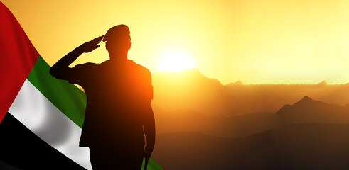 Silhouette Of A Solider Saluting Against the flag of UAE. Concept of national muslim holidays. Independence Day, Victory Day.